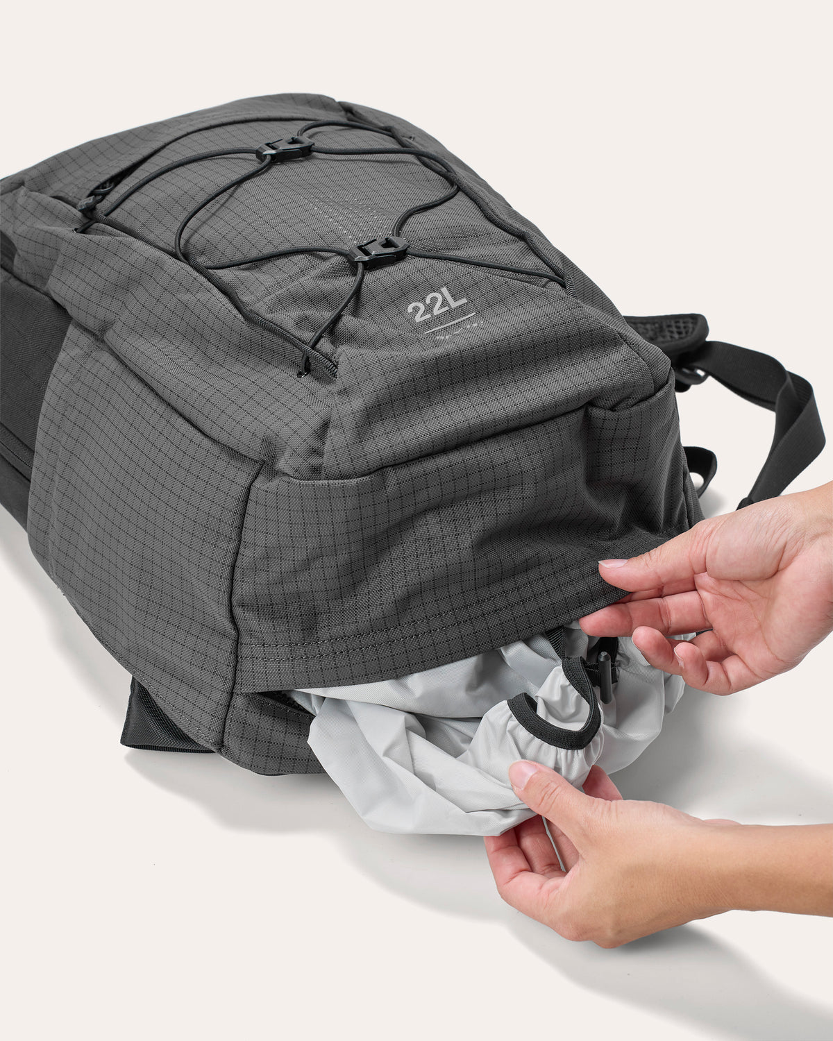 Waterproof rain cover integrated into a dedicated storage pocket at the bottom